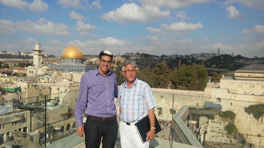 Two men overlooking Jerusalem skyline with Dome of the Rock