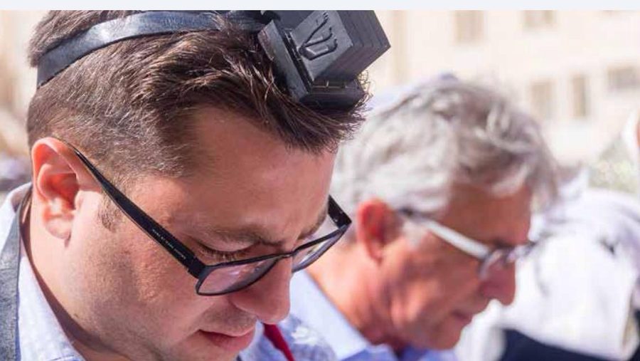 Quiet prayer at the Western Wall wearing tefilin